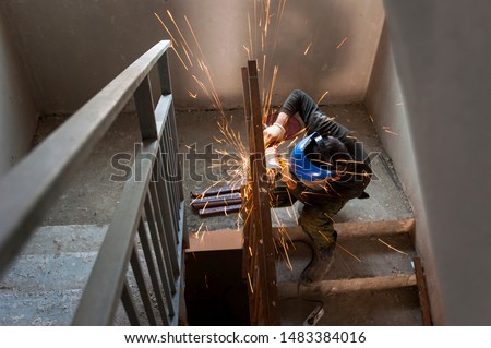 working at the construction site working angle grinder