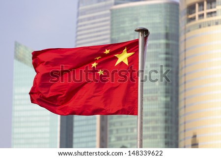 China's flag on the background of skyscrapers of Shanghai World Financial Center  Royalty-Free Stock Photo #148339622