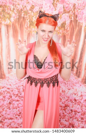 Beautiful redheaded young girl with fashion lace cat ears on head
