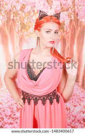 Beautiful redheaded young girl with fashion lace cat ears on head