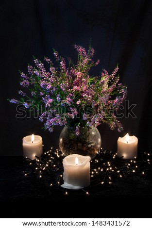 Mystical night composition with Heather and candles on black velvet