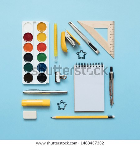 Blue background and yellow school supplies.  Back to school. Flat lay.


