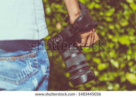 young man with reflex camera in his hand
