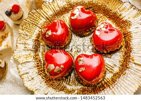 Small heart shaped cakes with red icing. St. Valentine's Day, Mother's Day, Birthday, Wedding banquet