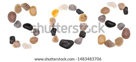 Word SOS (S.O.S. - Help!) handmade with stones (boulders). Collection words with stones. Isolated on white background