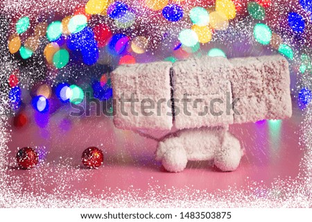 Christmas Festive Background. Toy car covered in snow carries boxes with gifts in the snow. Web Banner.