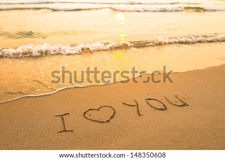I love you - inscription on the beach sand (soft surf wave)