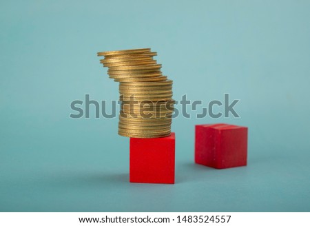 Coin Stack on red wooden block, income tax, property tax concept