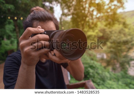 Nature photographer in forest taking pictures. thailand copy space