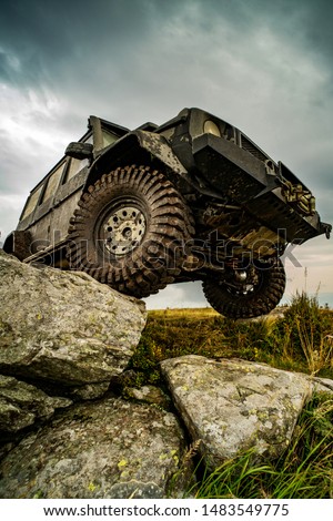 Off-road travel on mountain road. Car tire. Tire for offroad. Offroad vehicle stuck on impenetrable road after rain in the countryside Royalty-Free Stock Photo #1483549775