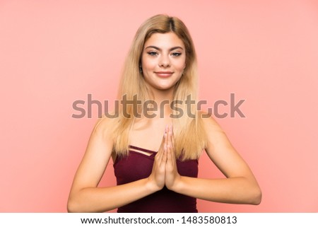Teenager girl over isolated pink background pleading
