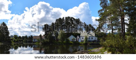 A panoramic view of a peaceful cottage surrounded by nature