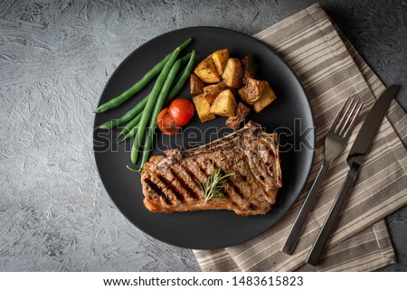 new york strip steak on concrete background Royalty-Free Stock Photo #1483615823