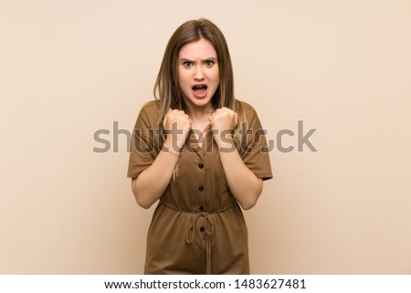 Teenager girl over isolated background frustrated by a bad situation