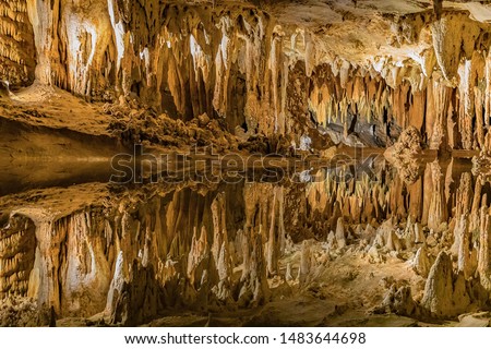Picture inside the Luray Caverns where a pool of water reflects the ceiling above.