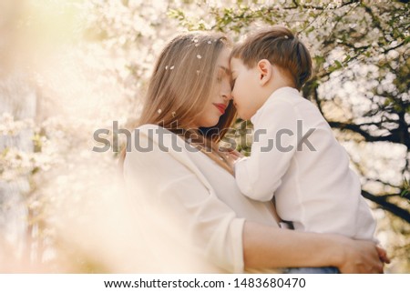 Family in a summer park. Mother in a white shirt. Cute little boy