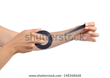 Woman hands holding and using an insulating tape isolated on a white background