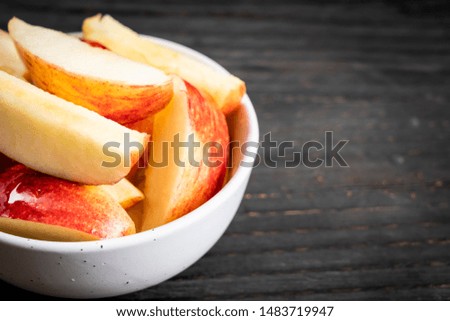 fresh red apples sliced bowl on wood background
