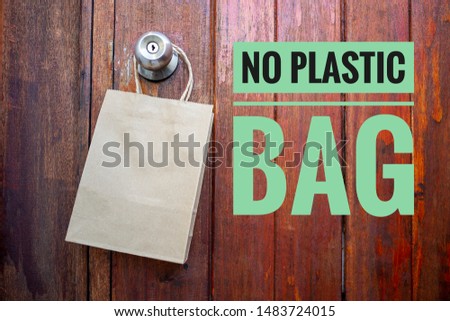 No plastic bag campaign logo wood background with Empty brown paper shopping bag hanging on old wooden door background