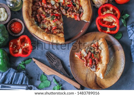 Photo of pizza on the table with ingredients around. Tasty pizza on the wooden background. Flat lay with top view. Italian pizza. Delicious pizza. Image