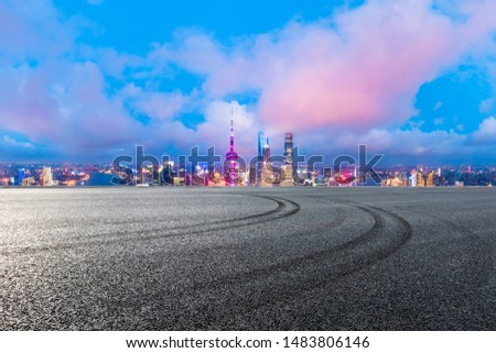 Shanghai skyline and modern buildings with empty race track at night,high angle view