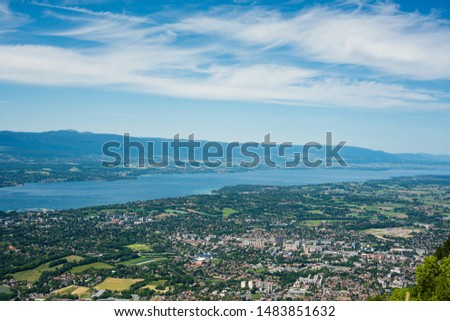 Breathtaking upper view to Geneva, city in Switzerland that lies at the southern tip of expansive Lac Léman (Lake Geneva) and little villages on a border with France. Alps, Jura mountains, Mont Blanc