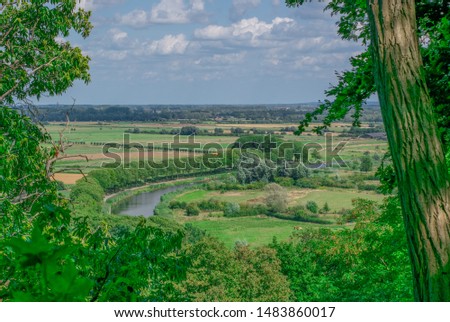 Dutch polder landscape seen from a hill through the trees the photo was taken in the Ooijpolder in the summer