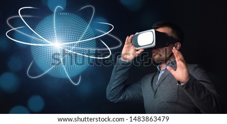 Man watching on planet with lines through virtual glasses on blue background, panorama, copy space