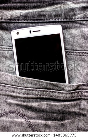 mobile phone in the back pocket of jeans modern style convenient means of communication