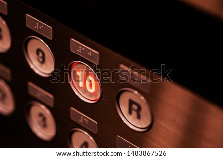 Close up elevator floor number buttons with light on selective focus