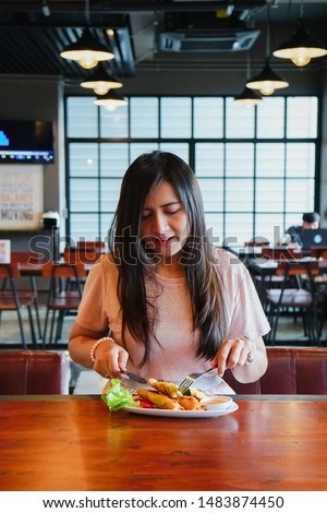 Asian woman is Ordering food and eating delicious thai food 