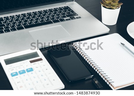 Smartphone and computer keyboard on office table close up