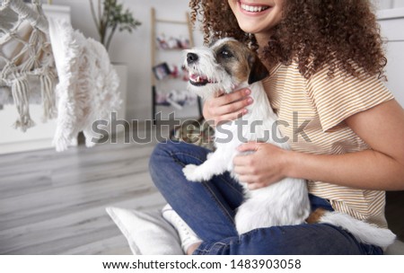 Close up of young woman embracing her dog 