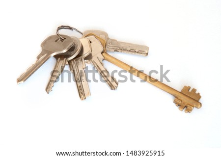 A bunch of modern door keys on ring on white background.