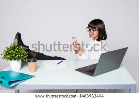 successful business woman resting at her desk on white background