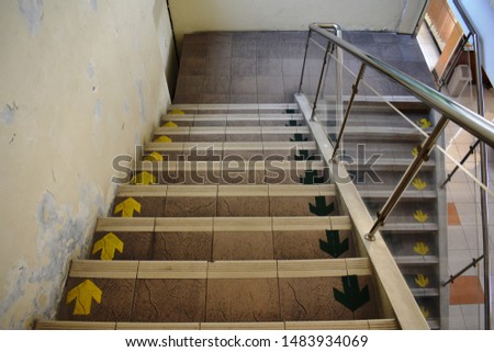 Stairs with arrows sign on a building.