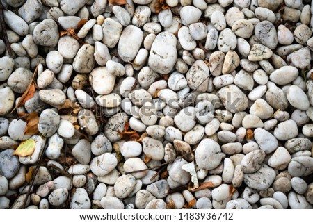 White smooth fireplaces. Pebble from the sea or ocean. Background. Horizontal orientation