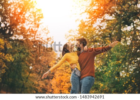 Happy to be in love. Young happy couple having fun in autumn park Royalty-Free Stock Photo #1483942691