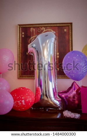 
Decoration for a children's party in delicate colors. One year old birthday present. Big inflatable birthday figure.