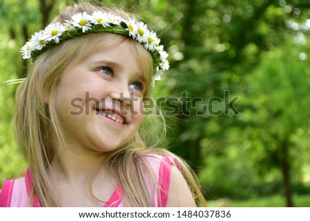 portrait of a girl with a wreath of daisies on her head