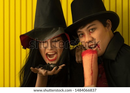 Asian young people attend a Halloween party which is dressed like devils, witche