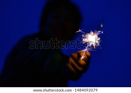 Person holding fireworks party fun