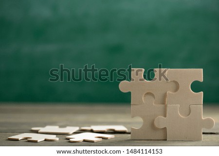 Creative solution for idea - business concept, jigsaw puzzle on the green blackboard background Royalty-Free Stock Photo #1484114153