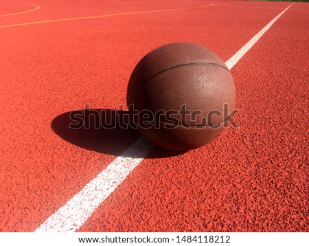 Basketball ball lies on the sports field