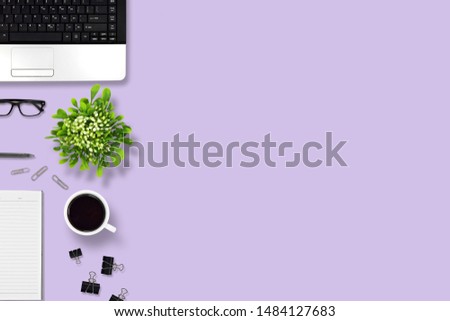 Top view office desk with laptop, pen, notebook, paper clip, glasses, Flower vase, coffee, supplies, with copy space background. Creative flat lay photo of workspace desk