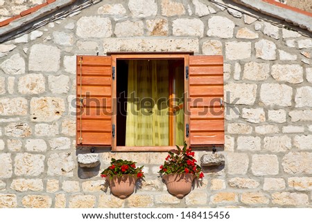 European Traditional House Facade. Open Window With Flowers. High quality stock photo.