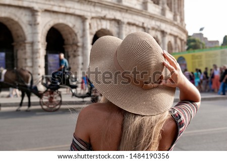 Travel woman with hat sitting and looking on the Colosseum, Rome. tourist in Italy