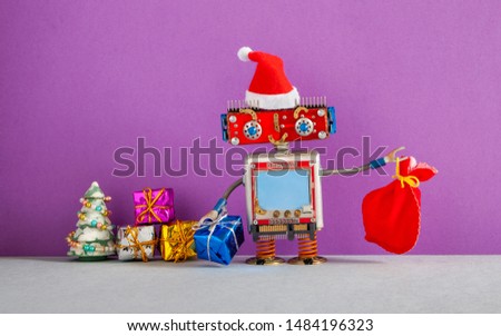 Smiling Santa Claus robot holding red bag and bright boxes with gifts. Merry Christmas Happy New Year poster. Copy space for text message robotic body interface. purple gray background.
