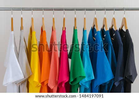 Close up of Colorful t-shirts on hangers, apparel cloth background Royalty-Free Stock Photo #1484197091
