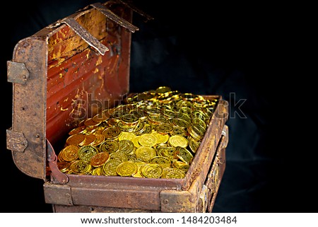 Stacking Gold Coin in treasure chest  on black background